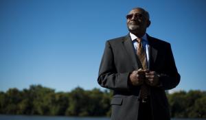 robert bullard, black man standing in suit with blue sky in background 
