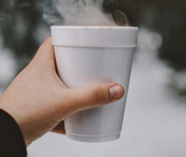 Hand holding a polystyrene cup, no longer allowed with NYC's Polystyrene Ban