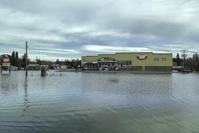 Flooding in an Alaskan town - a business is seen with water surrounding it. Prepare your business for an emergency.