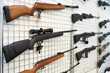 Image: guns on a rack. Title: Are You Unintentionally Investing in Gun Manufacturers?
