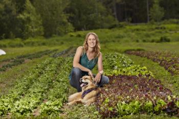 Photo of author with her dog on the farm.